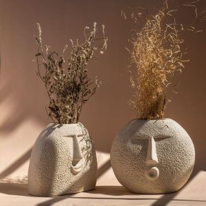 set of 2 oval shaped ceramic face vases in raw unglazed finish