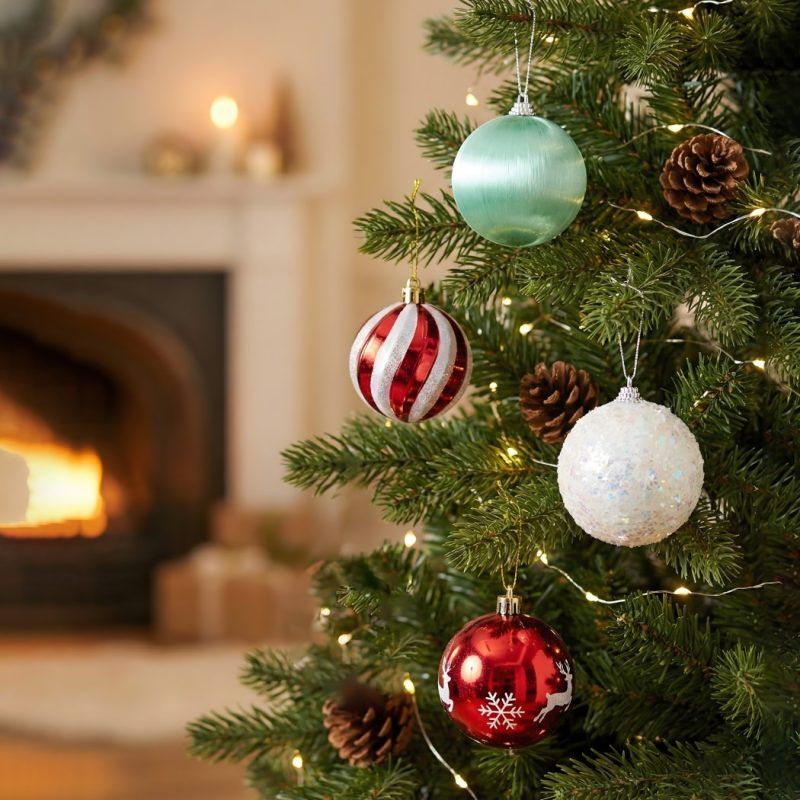 Christmas tree decorated with a mix of red, white, and mint green ornaments for a festive holiday look.