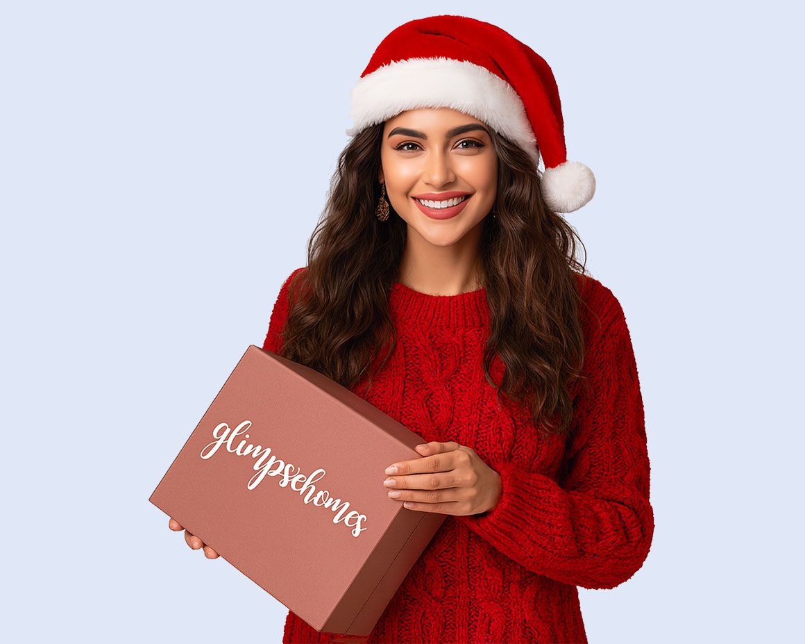 girl in red sweater wearing santa hat and holding glimpse homes gift box