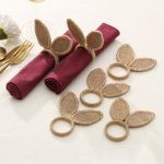 Collection of 6 natural jute bunny ear napkin rings shown with linen napkins, perfect for festive family dinners.