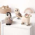 Close-up of Glimpse Homes handmade felt owl, penguin, and ram toys standing on a white shelf as nursery decor.