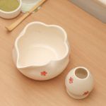 Top-down view showing the unique scalloped rim and pouring spout of the Glimpse Homes red floral ceramic matcha bowl and holder.