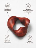 Infographic detailing the features of The Trinity Knot by Glimpse Homes: handmade in teak wood, bespoke mahogany brown matte finish, lightweight at 250 grams, and clean with a dry cloth.