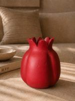 A large 7.5-inch ravishing red handmade terracotta pomegranate showpiece by Glimpse Homes, styled as an elegant center table decor in a living room.