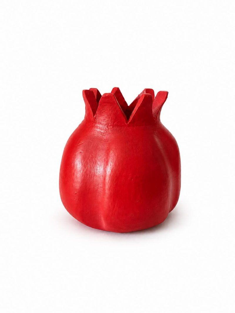 Front studio view of the handmade terracotta pomegranate showpiece in a semi-matte ravishing red finish by Glimpse Homes against a white background.