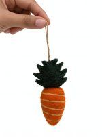 Hand holding a felt carrot ornament with jute string details, nursery decor piece