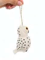 Hand holding a Glimpse Homes felt owl ornament showing spotted wings and hanging string
