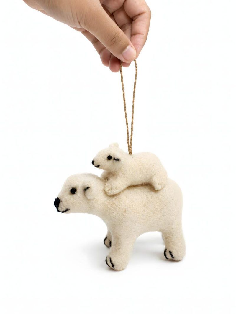 Glimpse Homes felt polar bear ornament with baby cub on its back, held by hand