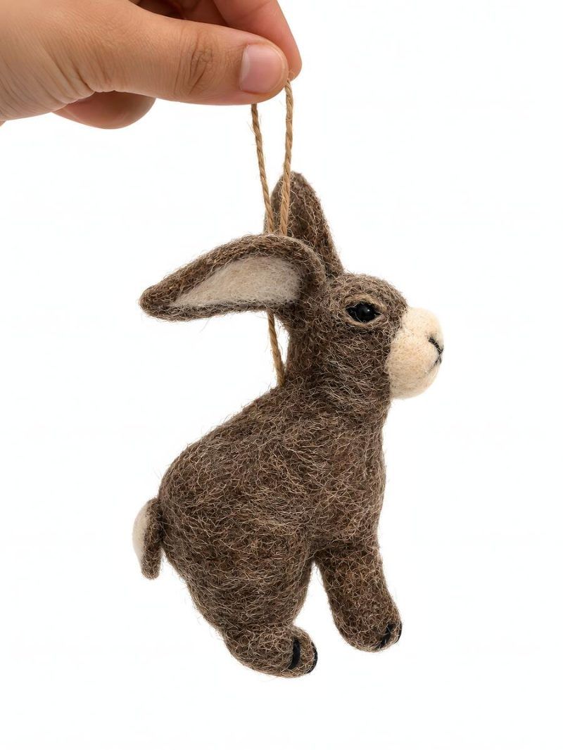 Hand holding a felt rabbit ornament to show size, brown wool felt bunny décor
