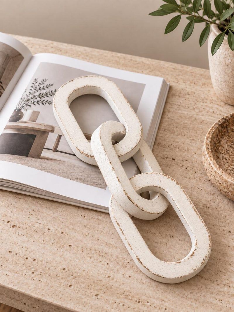 3 Knot Long Wooden Chain Decor in Vintage White Finish placed on a coffee table book.