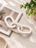 3 Knot Long Wooden Chain in Vintage White Finish styled on marble table with greenery.