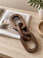 3 Knot Long Wooden Chain Decor in Walnut Finish placed on a coffee table book.