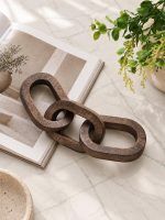 3 Knot Long Wooden Chain in Walnut Finish styled on marble table with greenery.