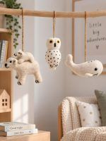 Glimpse Homes felt polar bear, owl and whale ornaments hanging on a wooden mobile in a kids' nursery room