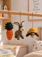 Glimpse Homes felt rabbit, tortoise and carrot ornaments hanging in a kids nursery room