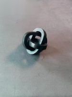 Small black triple knot wooden chain sculpture by Glimpse Homes, intertwined ring design home decor.