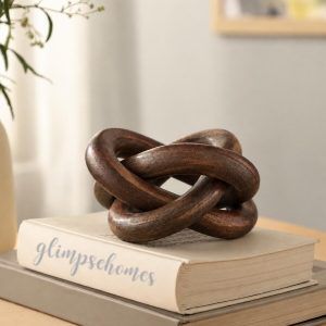Glimpse Homes walnut finish wooden knot chain decor piece styled on stacked books for home decor
