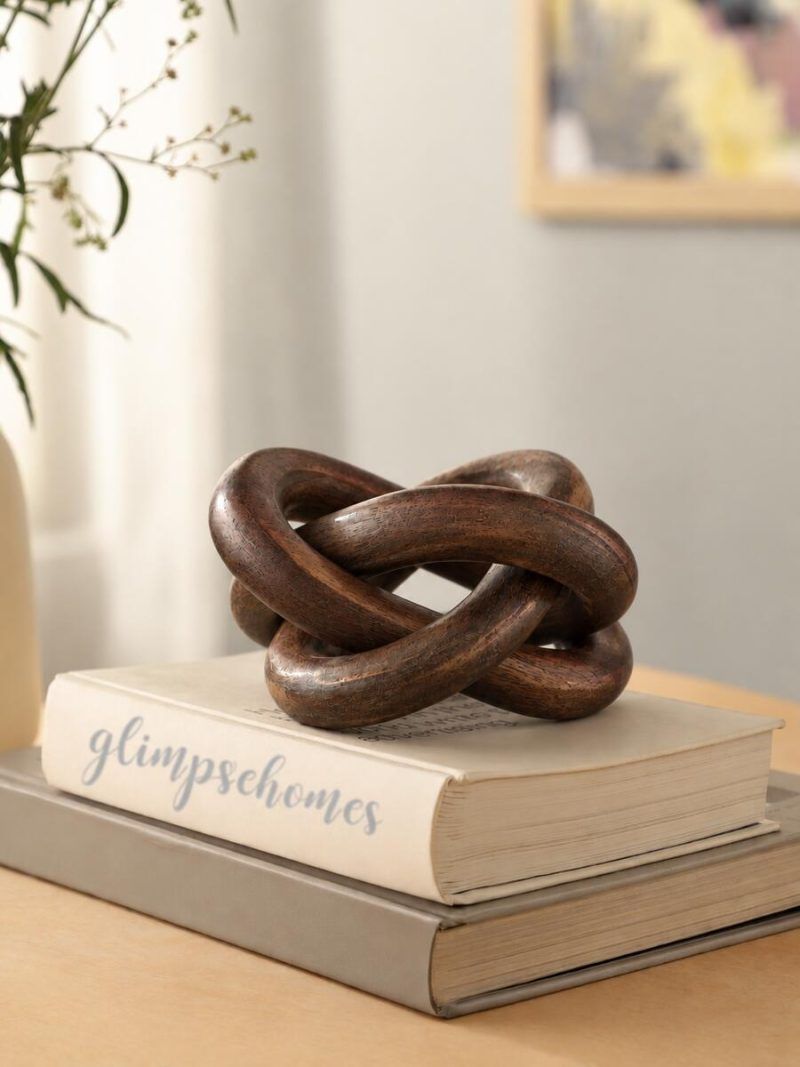 Glimpse Homes walnut finish wooden knot chain decor piece styled on stacked books for home decor